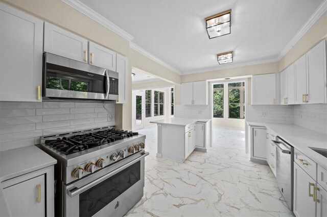 333 Woodland Way, Clemson, SC 29631 - kitchen featuring stainless steel appliances, decorative backsplash, light countertops, white cabinets, and ornamental molding