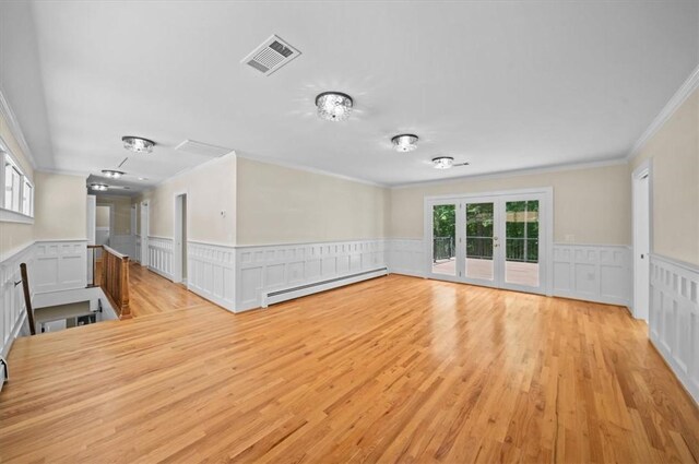 333 Woodland Way, Clemson, SC 29631 - unfurnished room featuring a baseboard radiator, crown molding, light wood-type flooring, a wainscoted wall, and a decorative wall