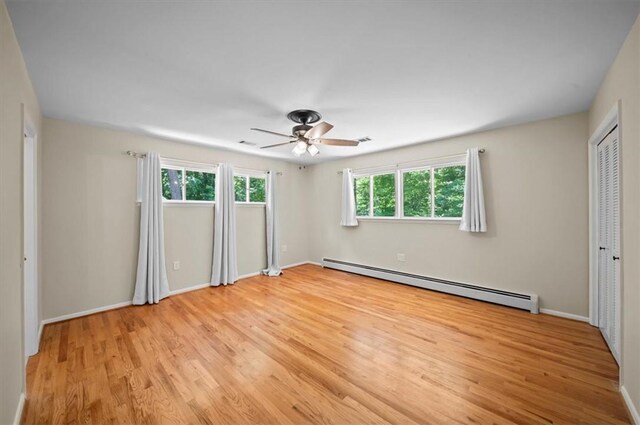 333 Woodland Way, Clemson, SC 29631 - unfurnished bedroom with baseboard heating, light wood-type flooring, and ceiling fan