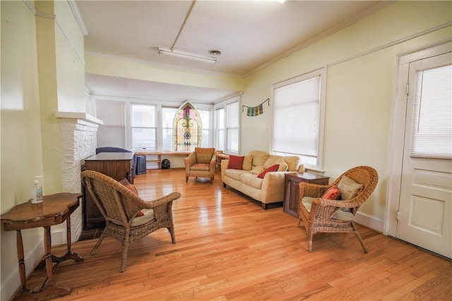206 W N 1st St, Seneca, SC 29678 - living room featuring light wood-type flooring, crown molding, and a stone fireplace
