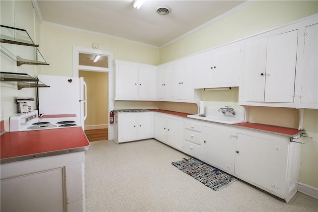 206 W N 1st St, Seneca, SC 29678 - kitchen featuring light floors, ornamental molding, white cabinets, and freestanding refrigerator