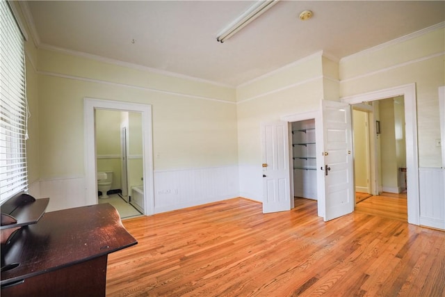 206 W N 1st St, Seneca, SC 29678 - unfurnished bedroom featuring ornamental molding, light wood finished floors, wainscoting, a spacious closet, and ensuite bathroom