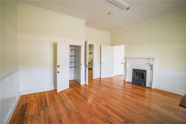 206 W N 1st St, Seneca, SC 29678 - unfurnished living room with a brick fireplace, wood finished floors, ornamental molding, and wainscoting