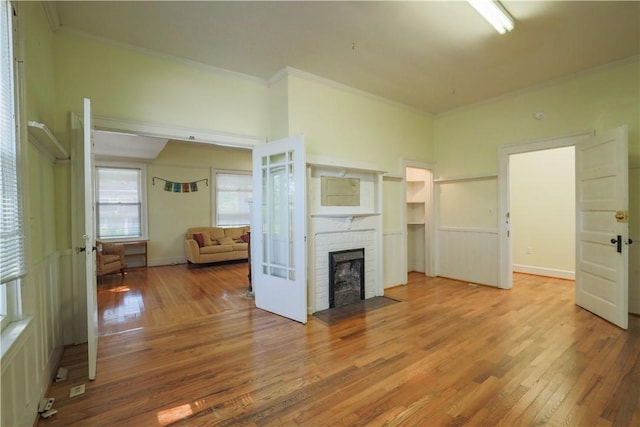 206 W N 1st St, Seneca, SC 29678 - unfurnished living room featuring wood-type flooring, crown molding, and a brick fireplace