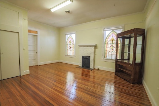 206 W N 1st St, Seneca, SC 29678 - unfurnished living room with a fireplace, wood-type flooring, healthy amount of natural light, and crown molding