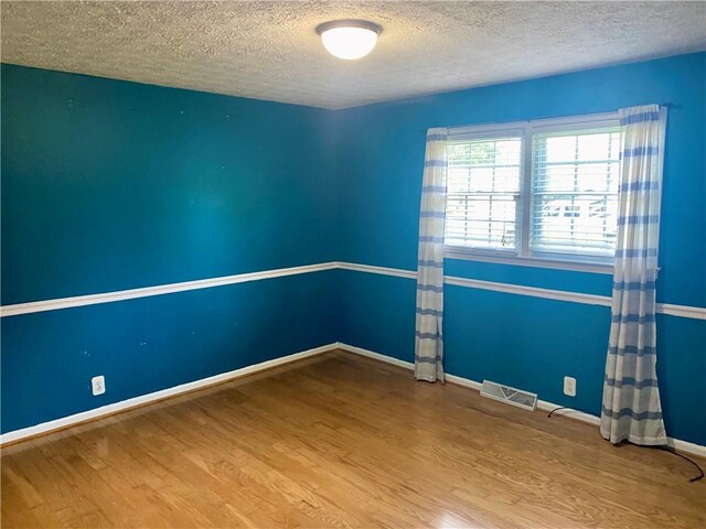 7 Carlisle Dr, Honea Path, SC 29654 - spare room featuring a textured ceiling, wood finished floors, and baseboards