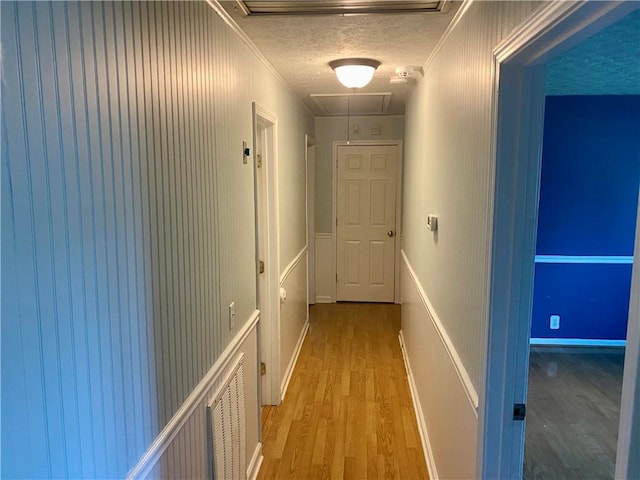 7 Carlisle Dr, Honea Path, SC 29654 - hallway featuring attic access, light wood-style floors, a textured ceiling, and crown molding