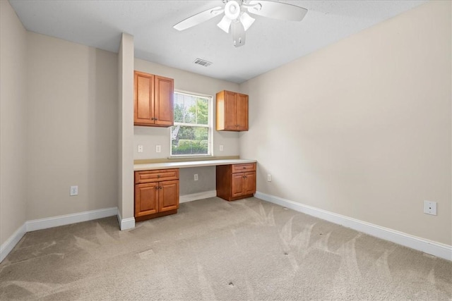 1814 Muscovy Way, Seneca, SC 29678 - kitchen with ceiling fan, light carpet, baseboards, light countertops, and brown cabinets