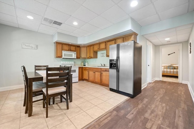 149 Summers Way, Seneca, SC 29672 - kitchen featuring white appliances, a drop ceiling, light countertops, baseboards, and a sink