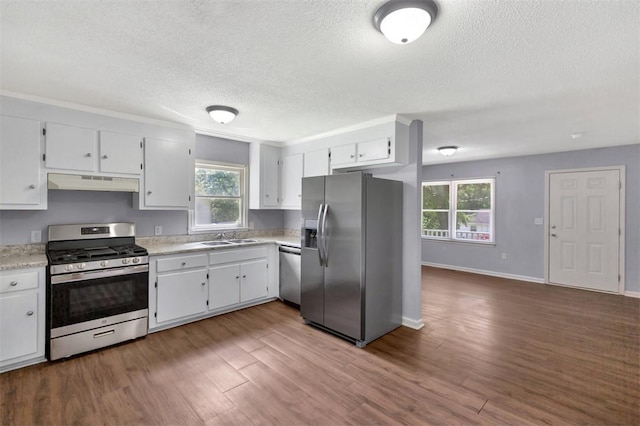 301 Wardlaw St, Anderson, SC 29624 - kitchen with appliances with stainless steel finishes, under cabinet range hood, a sink, light countertops, and a textured ceiling