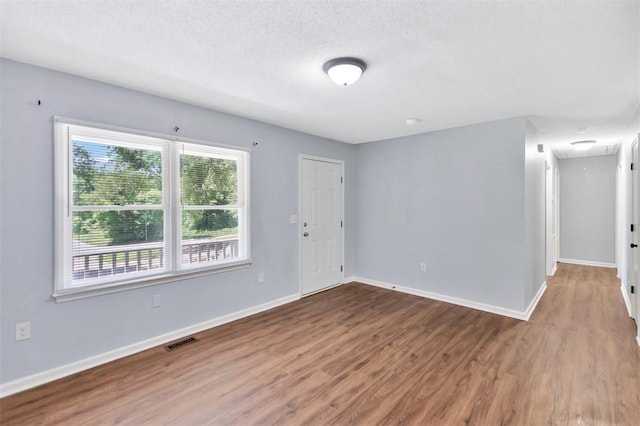 301 Wardlaw St, Anderson, SC 29624 - unfurnished room with attic access, wood finished floors, baseboards, and a textured ceiling