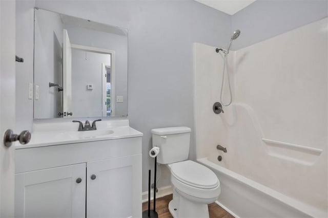 301 Wardlaw St, Anderson, SC 29624 - full bath with toilet, vanity, washtub / shower combination, wood finished floors, and baseboards
