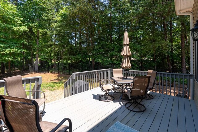 606 Lighthouse Ct, Seneca, SC 29672 - wooden terrace with outdoor dining area, a fenced backyard, and view of wooded area
