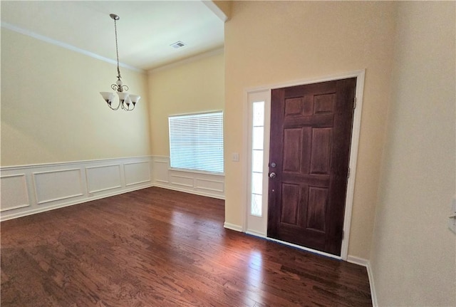 605 Spirit Mountain Ln, Easley, SC 29640 - entrance foyer with crown molding, dark wood-style floors, a chandelier, and wainscoting