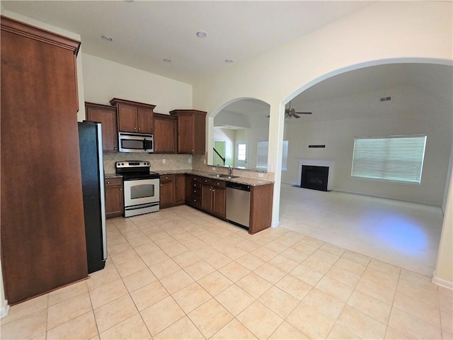 605 Spirit Mountain Ln, Easley, SC 29640 - kitchen featuring appliances with stainless steel finishes, arched walkways, ceiling fan, a sink, and open floor plan