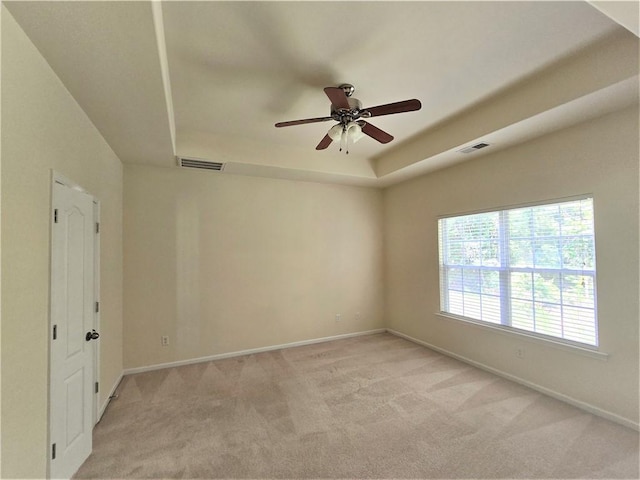 605 Spirit Mountain Ln, Easley, SC 29640 - unfurnished room featuring a tray ceiling, ceiling fan, light carpet, and baseboards