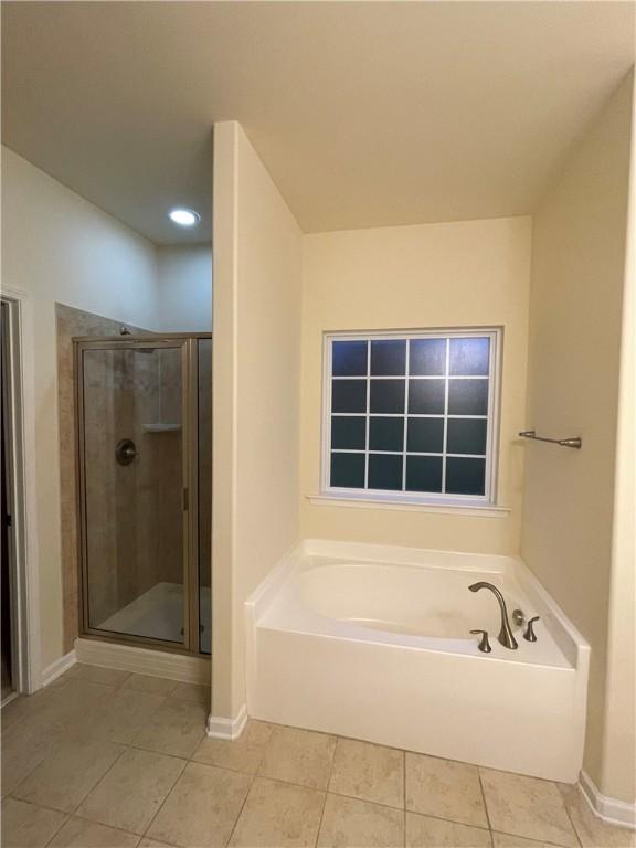 605 Spirit Mountain Ln, Easley, SC 29640 - full bath with tile patterned flooring, a bath, a stall shower, and baseboards
