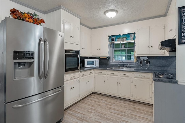 304 Samuel Rd, Honea Path, SC 29654 - kitchen with appliances with stainless steel finishes, a sink, range hood, dark countertops, and a textured ceiling
