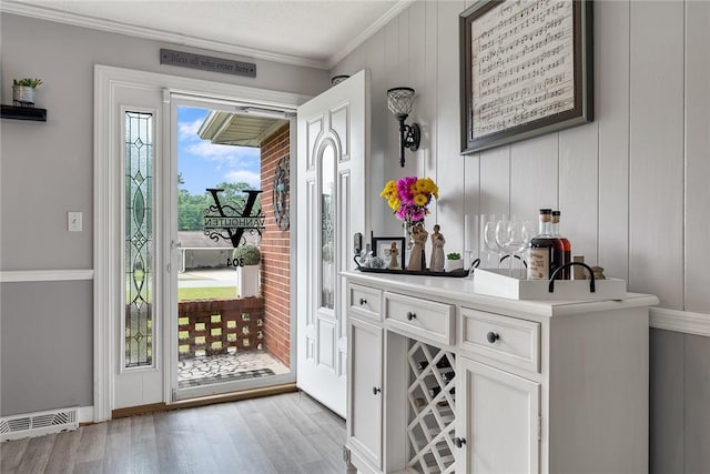 304 Samuel Rd, Honea Path, SC 29654 - entrance foyer featuring light wood-type flooring, ornamental molding, and bar