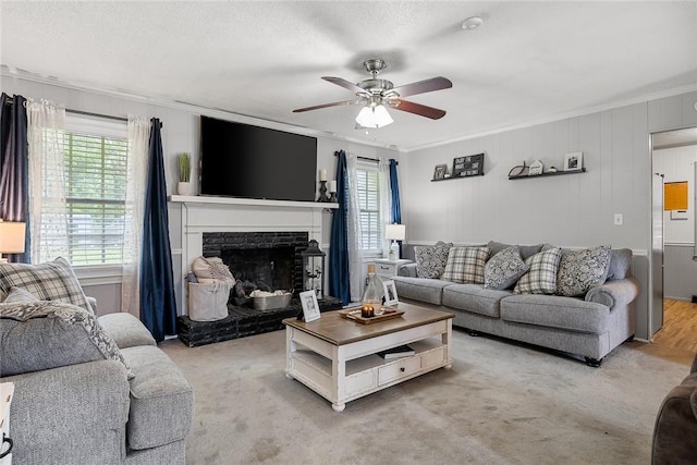 304 Samuel Rd, Honea Path, SC 29654 - living area featuring ornamental molding, a ceiling fan, a fireplace, and light colored carpet
