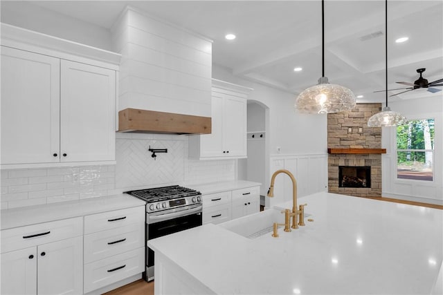 104 Hart Rd, Anderson, SC 29621 - kitchen featuring stainless steel range with gas cooktop, a sink, light countertops, white cabinets, and tasteful backsplash