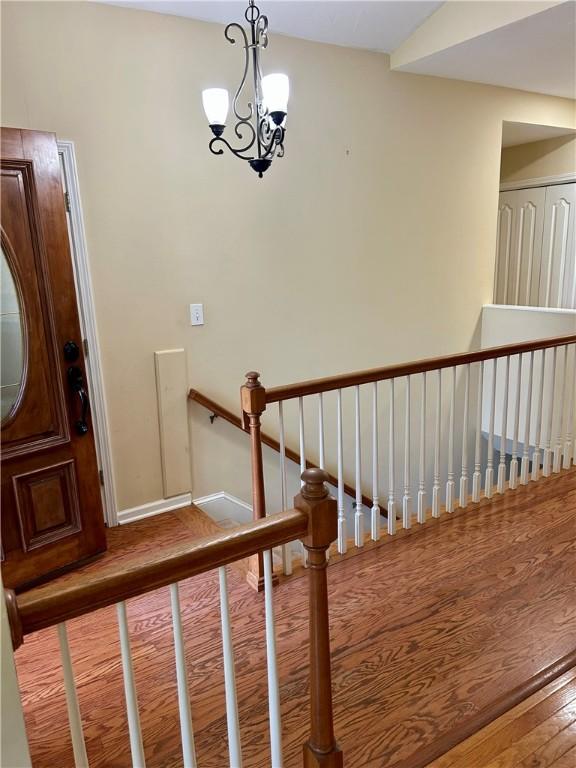 105 Eagle Ct, Westminster, SC 29693 - stairway with hardwood / wood-style flooring, a chandelier, and baseboards
