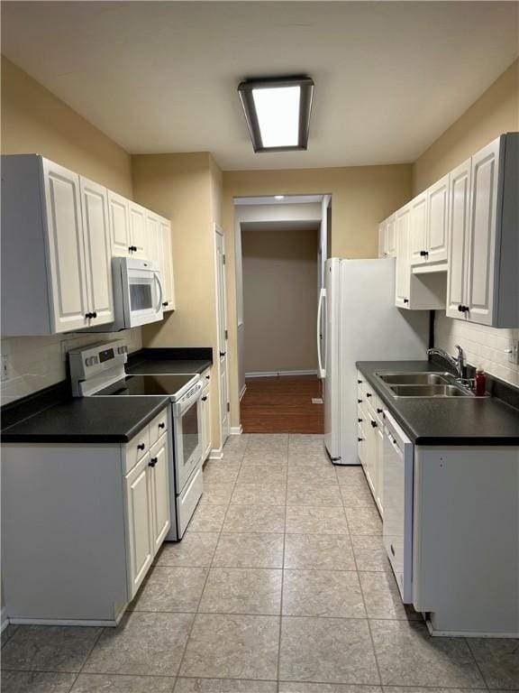 105 Eagle Ct, Westminster, SC 29693 - kitchen with white appliances, a sink, dark countertops, backsplash, and light tile patterned flooring