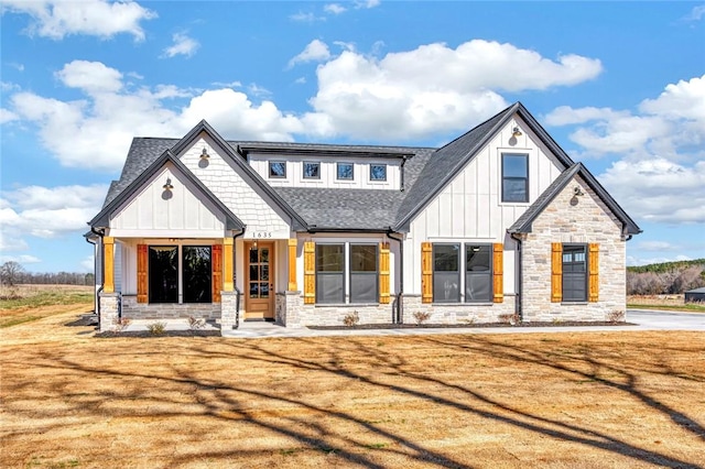 1621 Old Dobbins Bridge Rd, Townville, SC 29689 - view of front of home featuring stone siding, board and batten siding, a shingled roof, and a front lawn