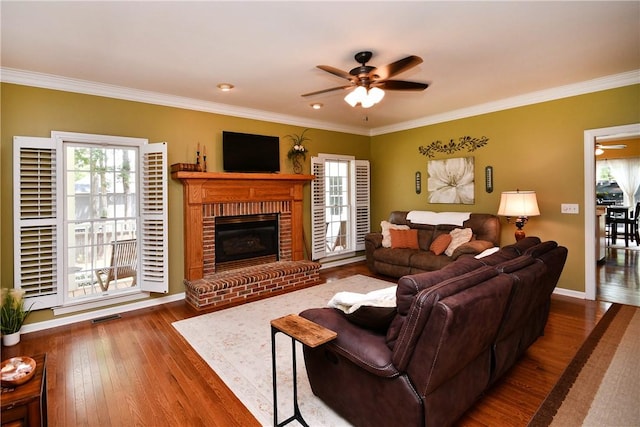 203 Tulip Tree Ct, Easley, SC 29642 - living area featuring healthy amount of natural light, a ceiling fan, wood finished floors, crown molding, and a fireplace
