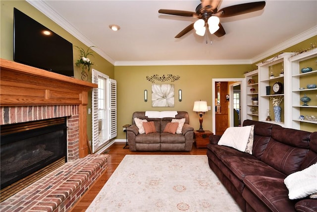 203 Tulip Tree Ct, Easley, SC 29642 - living area featuring dark wood-style floors, ornamental molding, ceiling fan, and a fireplace