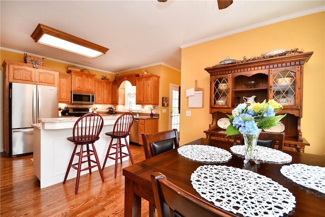 203 Tulip Tree Ct, Easley, SC 29642 - dining area featuring crown molding, light wood-type flooring, and a ceiling fan
