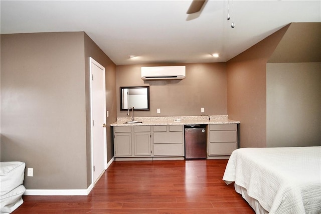 203 Tulip Tree Ct, Easley, SC 29642 - bedroom featuring a wall mounted AC, fridge, a sink, and dark wood finished floors