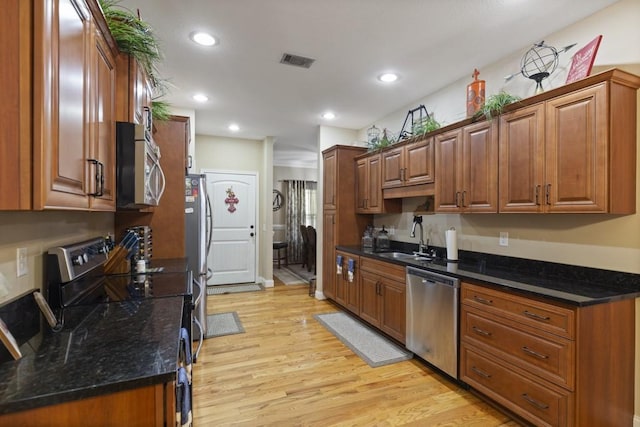 6352 Valley Farm Rd, Seneca, SC 29678 - kitchen with stainless steel appliances, a sink, light wood-style flooring, brown cabinetry, and recessed lighting