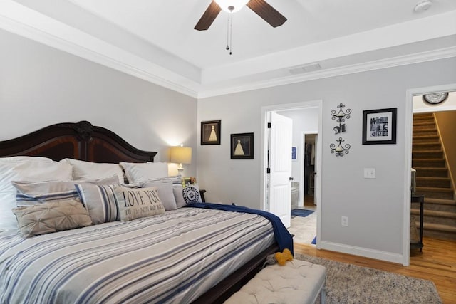 6352 Valley Farm Rd, Seneca, SC 29678 - bedroom with light wood-type flooring, baseboards, a tray ceiling, crown molding, and a ceiling fan