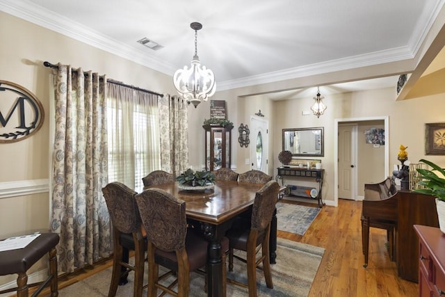 6352 Valley Farm Rd, Seneca, SC 29678 - dining area with a chandelier, ornamental molding, and wood finished floors