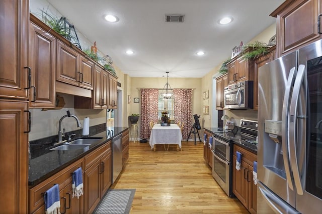 6352 Valley Farm Rd, Seneca, SC 29678 - kitchen with stainless steel appliances, a sink, light wood-style floors, recessed lighting, and hanging light fixtures
