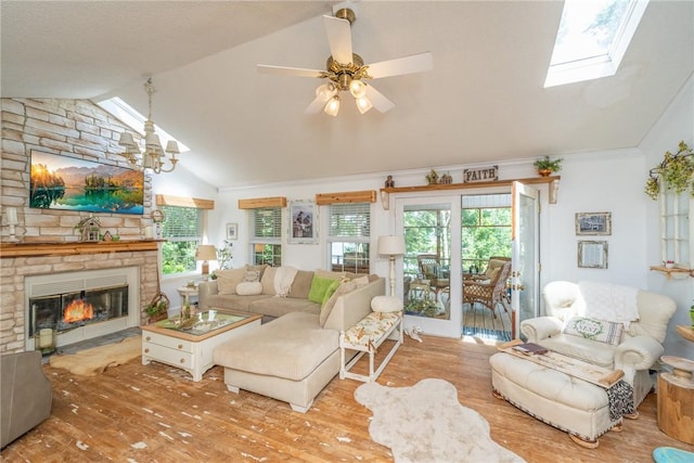 79 Blue Heron Cv, Abbeville, SC 29620 - living room with vaulted ceiling, wood finished floors, healthy amount of natural light, and a stone fireplace