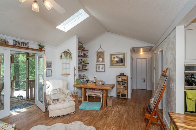 79 Blue Heron Cv, Abbeville, SC 29620 - living area with wood finished floors, lofted ceiling, a skylight, ceiling fan, and a textured ceiling