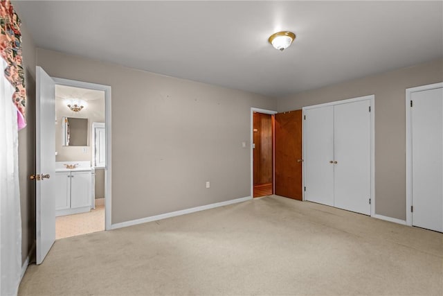 2909 Olive St, Anderson, SC 29625 - unfurnished bedroom with light colored carpet, connected bathroom, and multiple closets