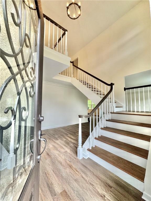 102 Buckingham Ct, Easley, SC 29640 - entryway with stairs, wood finished floors, a towering ceiling, and baseboards