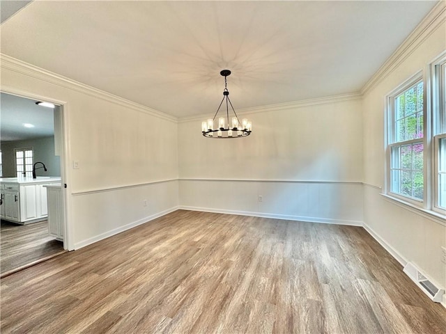 102 Buckingham Ct, Easley, SC 29640 - unfurnished room with wood finished floors, a chandelier, ornamental molding, a sink, and baseboards