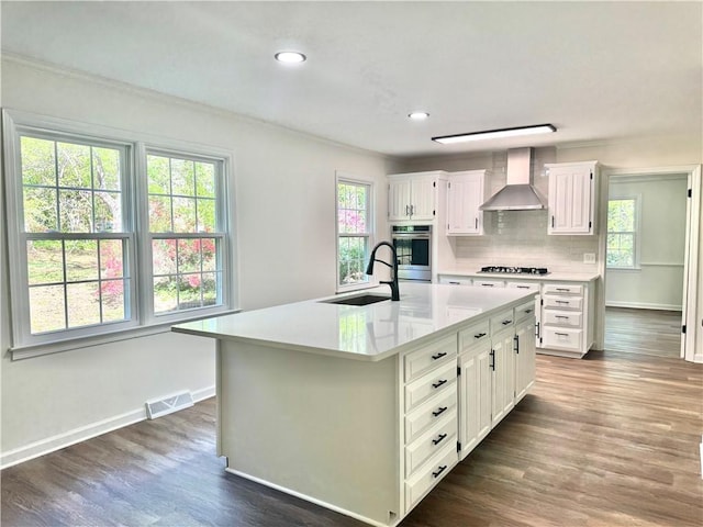 102 Buckingham Ct, Easley, SC 29640 - kitchen with wall chimney range hood, a sink, gas cooktop, light countertops, and plenty of natural light