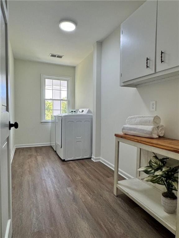 102 Buckingham Ct, Easley, SC 29640 - laundry area with cabinet space, dark wood finished floors, separate washer and dryer, and baseboards