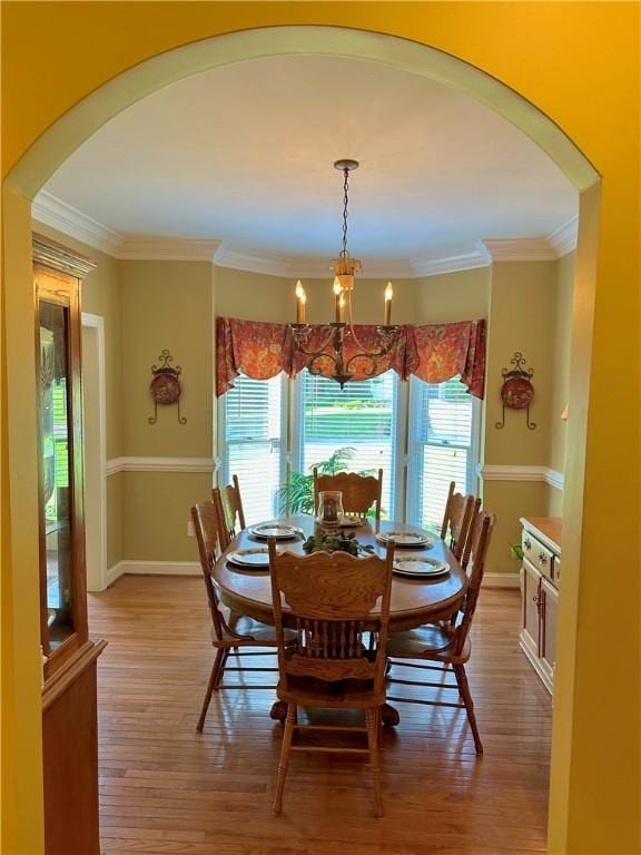 307 Holly Ridge Dr, Anderson, SC 29621 - dining room with arched walkways, a chandelier, light wood-type flooring, plenty of natural light, and ornamental molding
