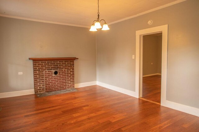 200 Bulwinkle Dr, Walhalla, SC 29691 - unfurnished living room featuring wood finished floors, a chandelier, crown molding, and a brick fireplace