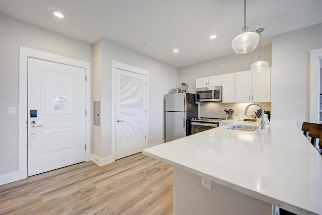 13500 Clemson Blvd Unit 2410, Seneca, SC 29678 - kitchen featuring stainless steel appliances, light countertops, light wood-type flooring, a peninsula, and white cabinets