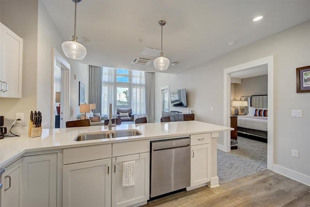 13500 Clemson Blvd Unit 2410, Seneca, SC 29678 - kitchen featuring stainless steel dishwasher, a peninsula, open floor plan, light wood-style flooring, and white cabinets