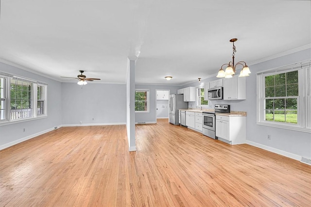 440 Cooley Bridge Rd, Pelzer, SC 29669 - kitchen featuring stainless steel appliances, crown molding, ceiling fan, light countertops, and open floor plan