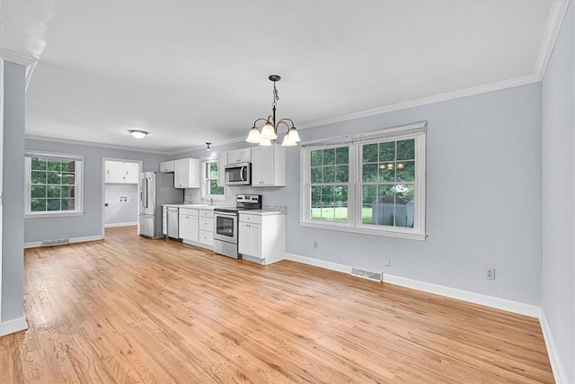 440 Cooley Bridge Rd, Pelzer, SC 29669 - kitchen with stainless steel appliances, a chandelier, crown molding, light countertops, and light wood finished floors