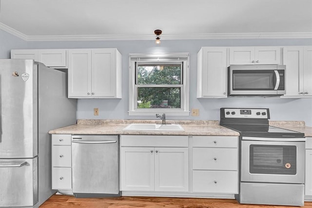 440 Cooley Bridge Rd, Pelzer, SC 29669 - kitchen featuring appliances with stainless steel finishes, light countertops, white cabinets, and ornamental molding